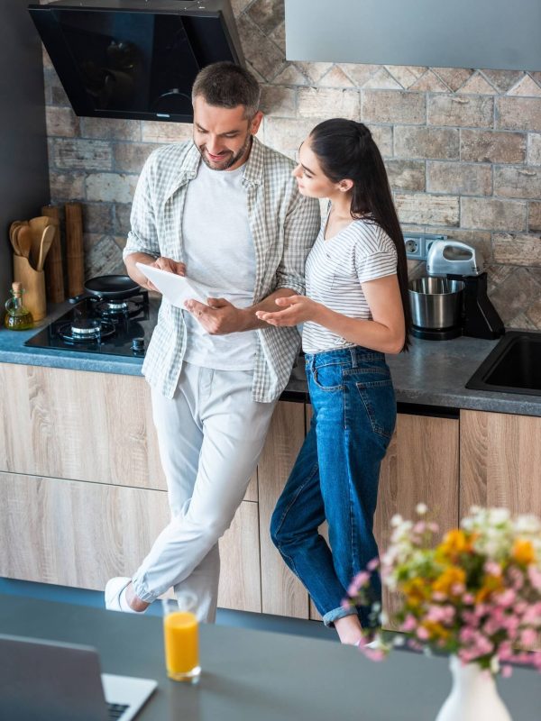 married-couple-using-digital-tablet-together-in-kitchen-smart-home-concept-1.jpg